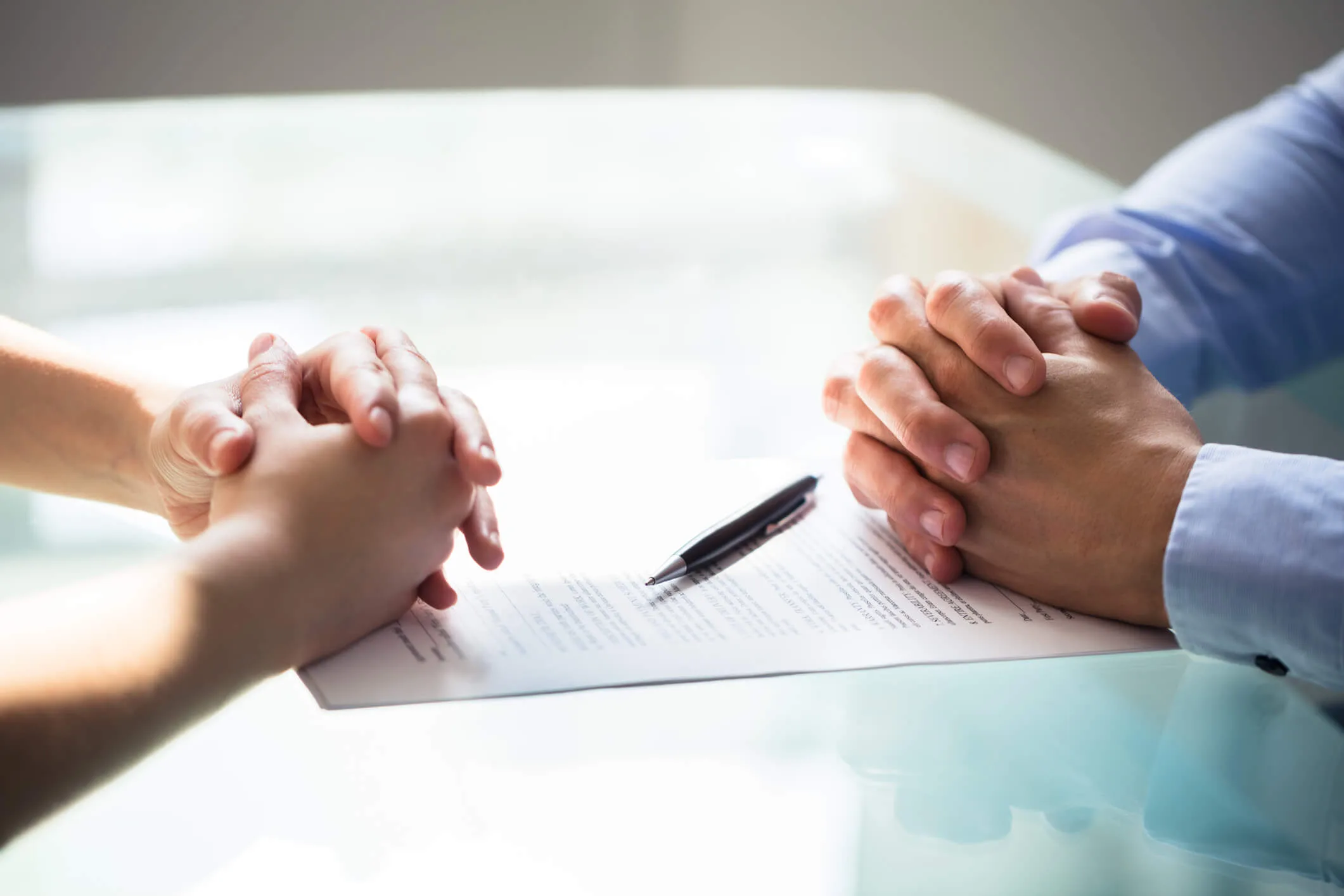 two figures and a legal document in front of them