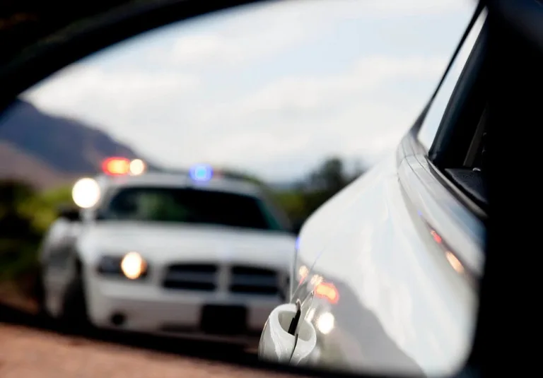 Police officer pulls over driver for one of New York's traffic law violations.