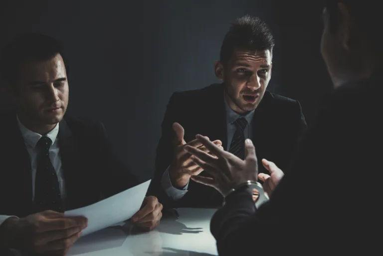 Man having a conversation with his defense lawyer