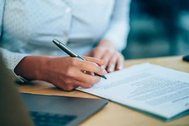 Woman signing divorce documents