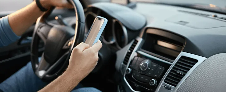 Man driving while on his phone