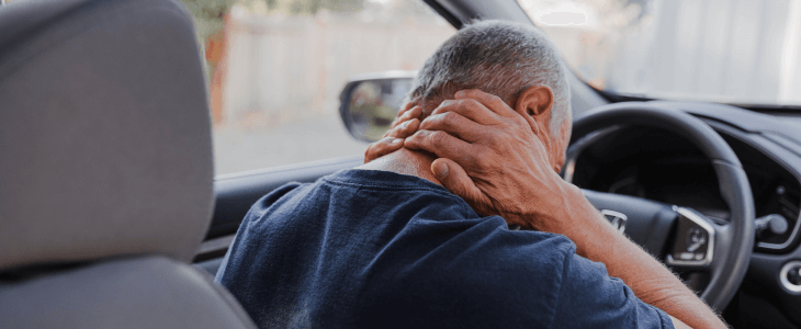 Man holding his neck after a whiplash injury