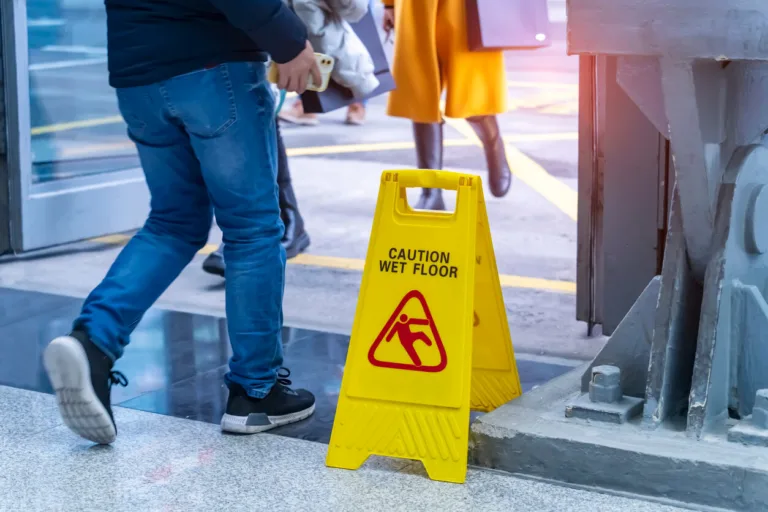 Caution wet floor sign near a step